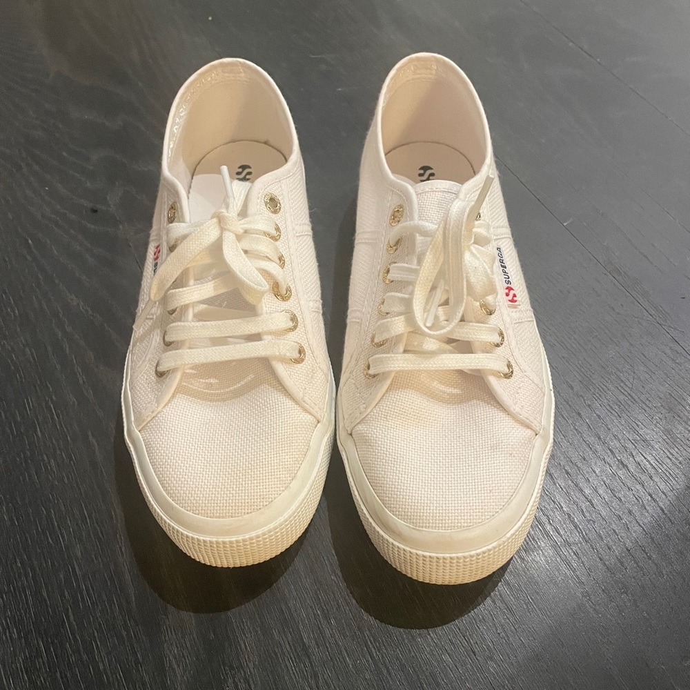 Barely worn white superga sneakers w gold grommets.